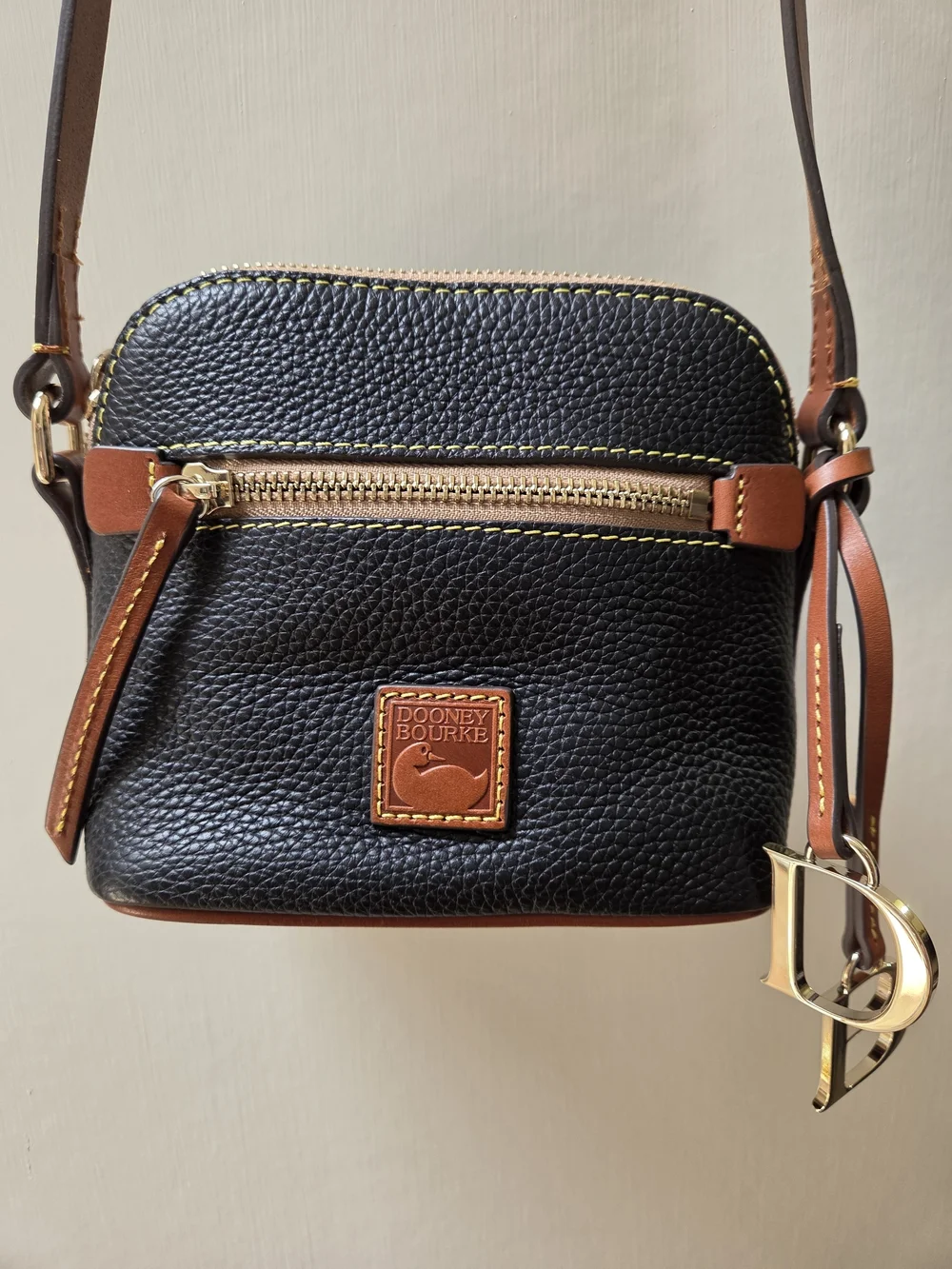 Dooney & Bourke NWT Black Pebble Leather Crossbody with Brown Trim. Logo charms